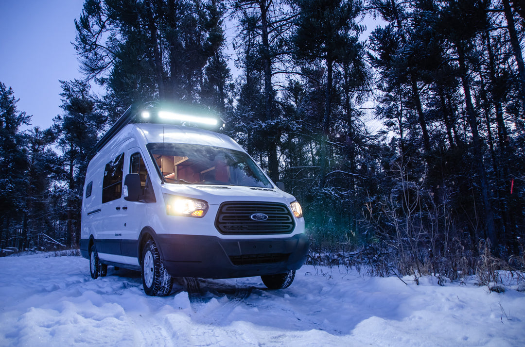 Ford Transit conversion with a light bar and roof rack