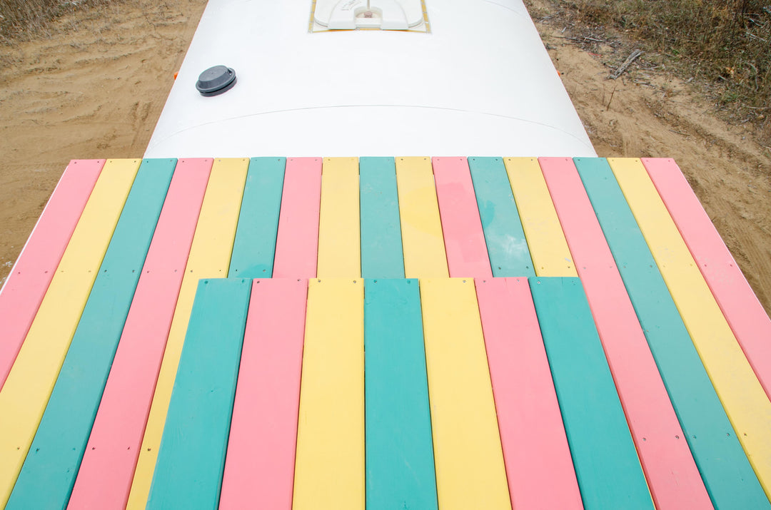 rainbow skoolie rooftop deck on a school bus conversion