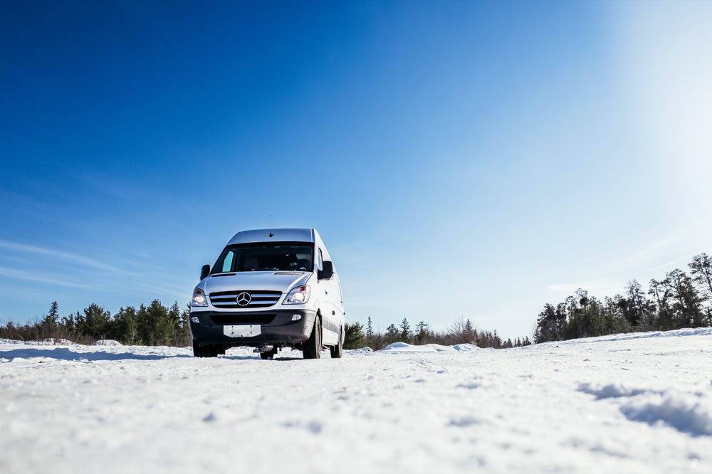 White Mercedes-Benz Sprinter camper van in winter built by 2Pines